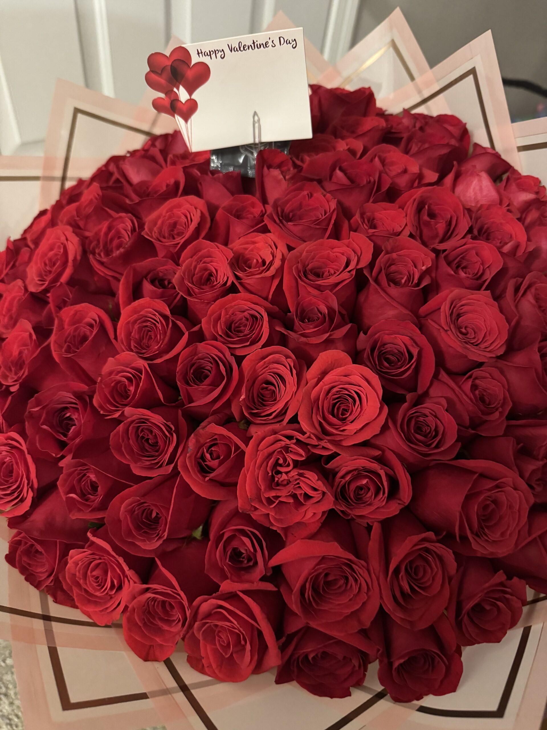 100 roses with crystal centers and gold butterfly accents by Fleur Sisters